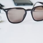 brown sunglasses on white wooden table